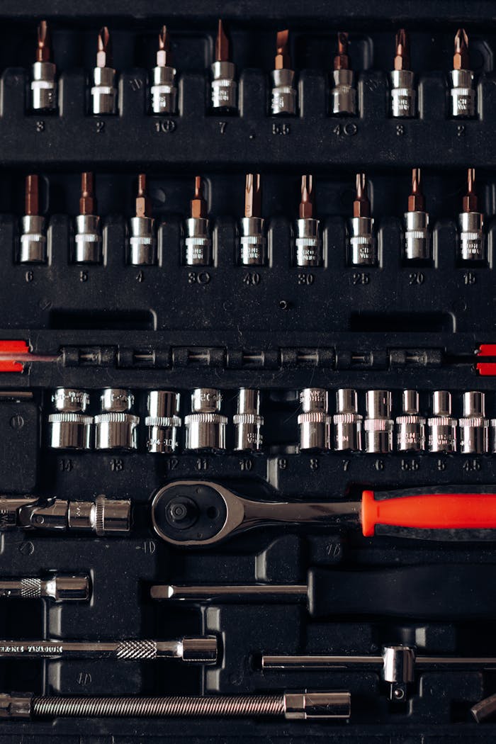 Close-up of an organized tool set kit with various driver bits and sockets.